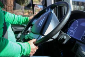Truck driver with hands on steering wheel