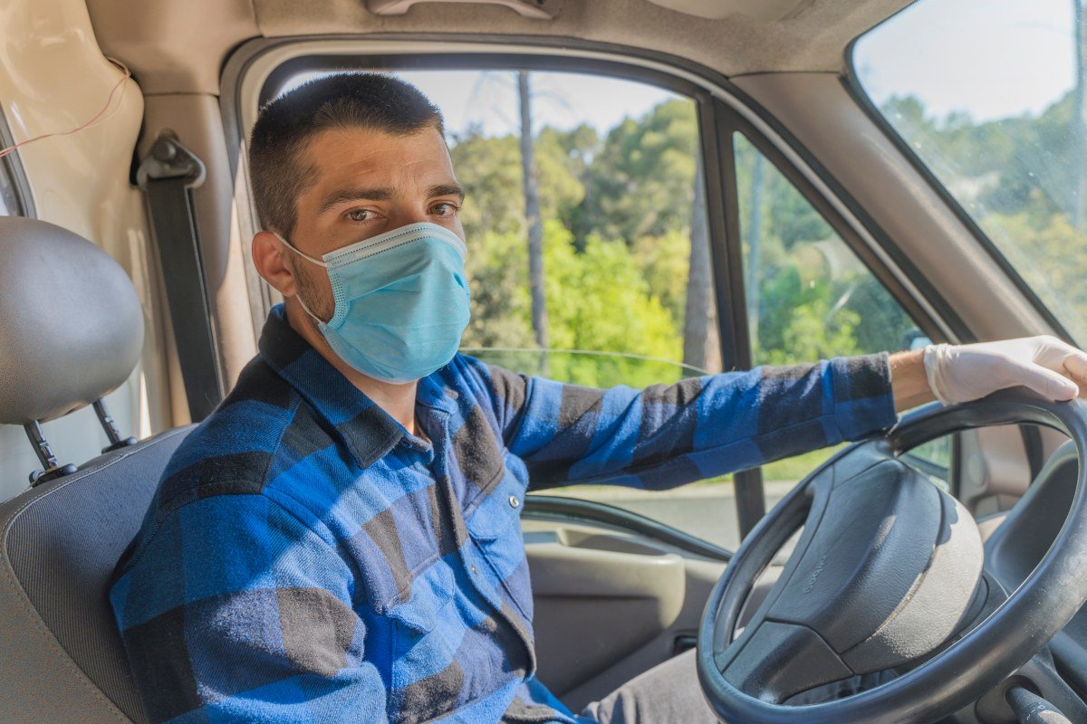 Coronavirus. Courier portrait in protective mask and rubber gloves make delivery service. Delivery service under quarantine, disease outbreak, coronavirus pandemic conditions. Transportation. Heroes.