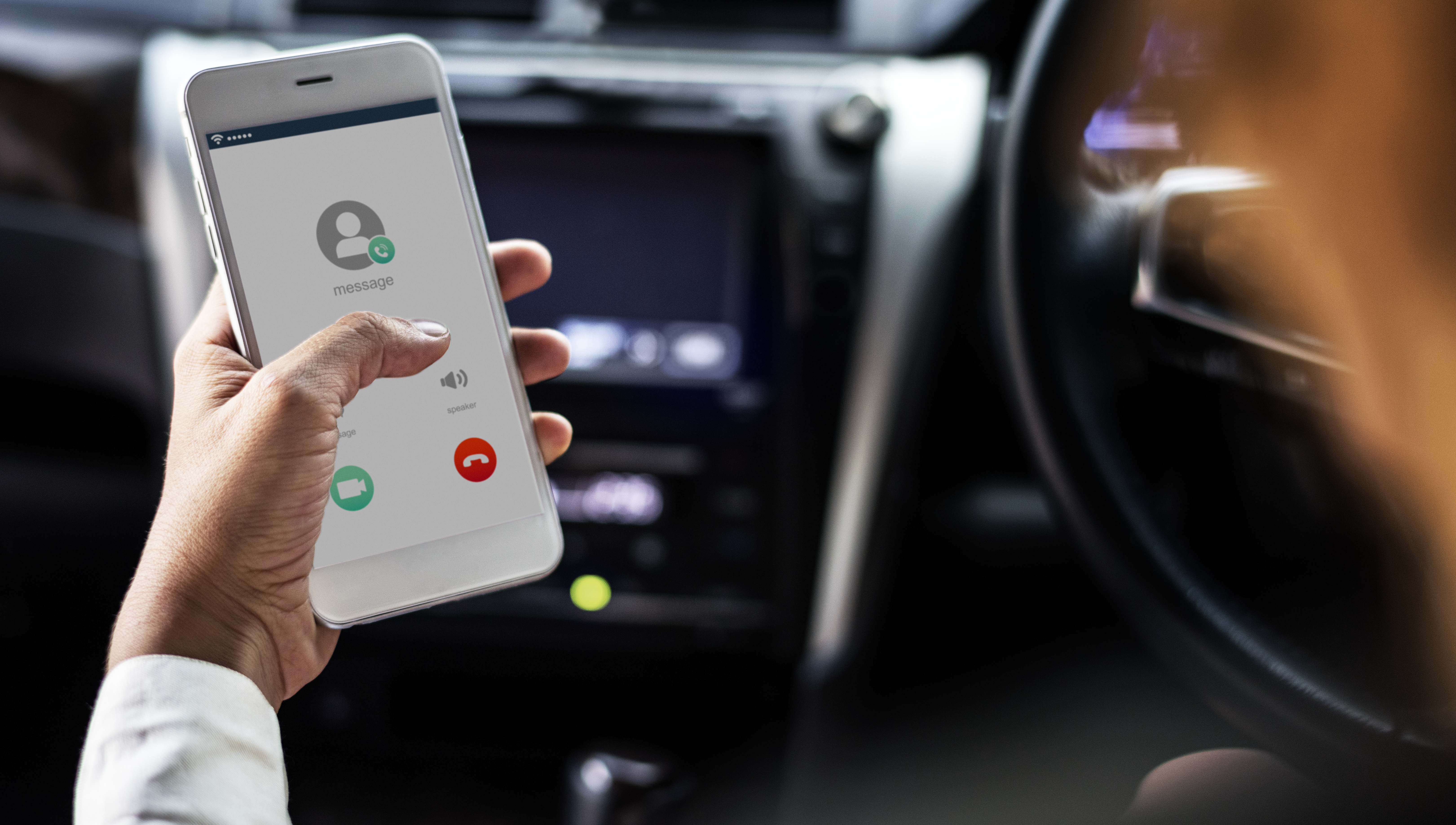 Woman using the mobile while in the car