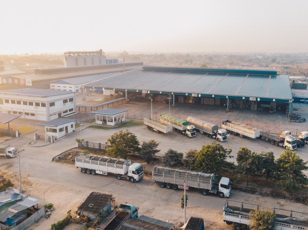 aerial view factory trucks parked near warehouse