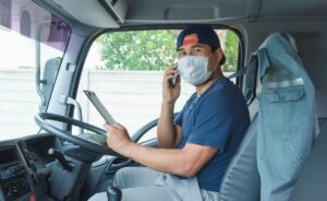 truck driver wearing masks to protect against dust and the spread of the flu. Covid 19.