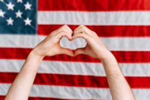 hand heart against American flag