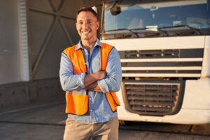 Delivery man standing in front of his truck