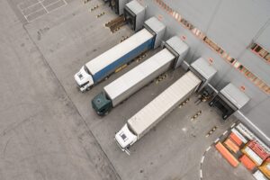 Aerial view of trucks unloading in logistics center