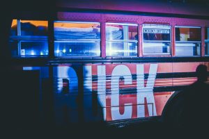 White and red bus on road during night time