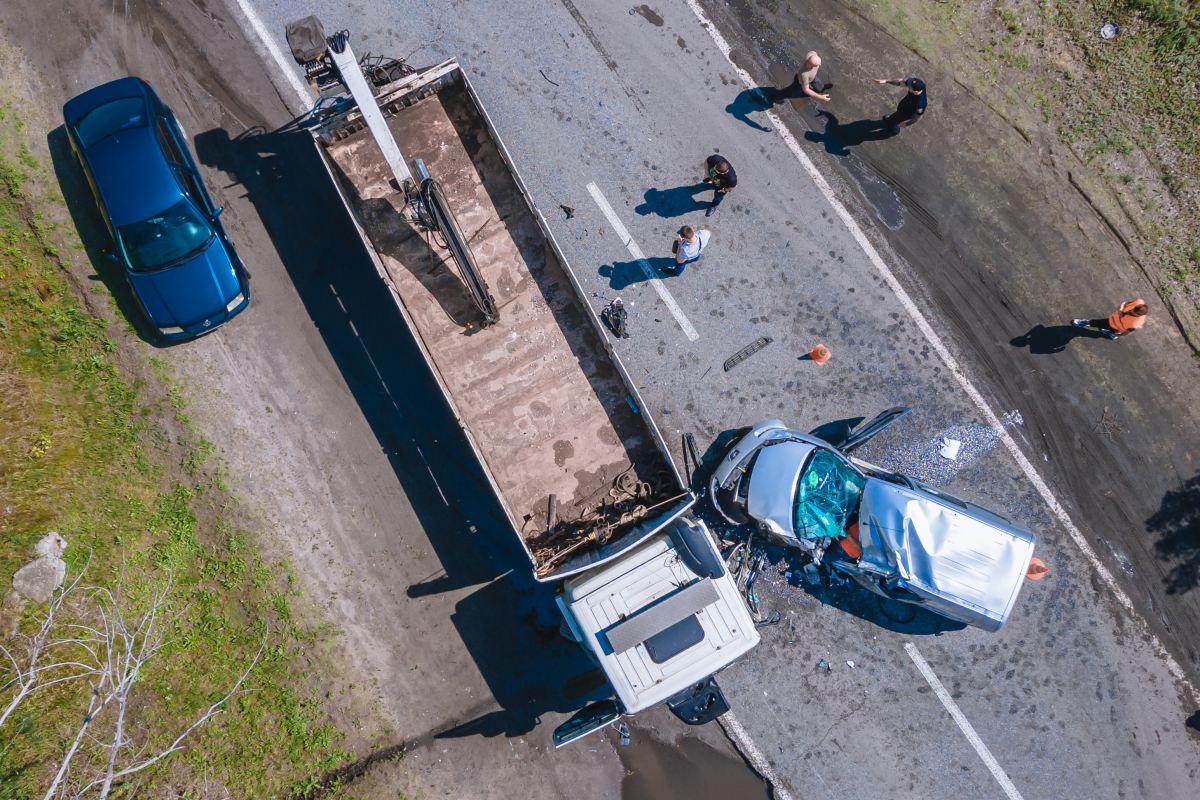 The truck and the car collided on the highway. Strong accident. Traffic accidents on the road. View from above. Traffic jam on the road.