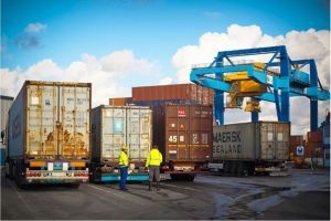 Men standing next to trucks