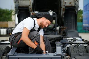 man servicing a truck