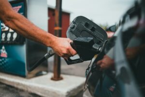 person filling up vehicle with fuel