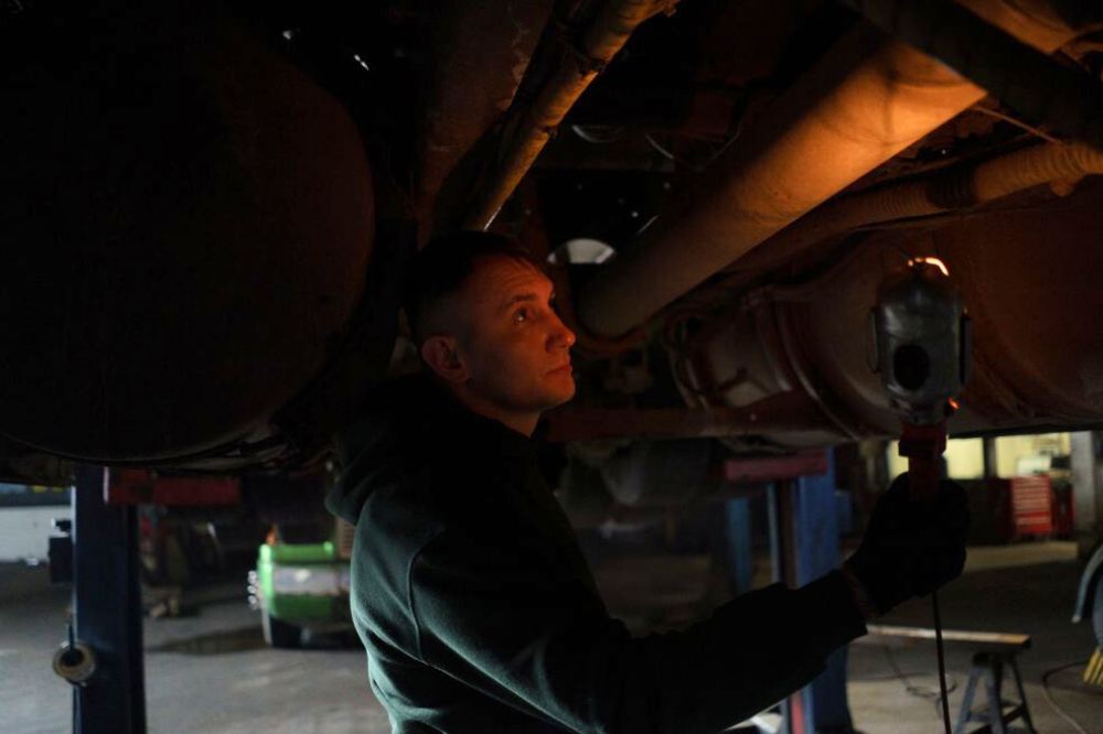 mechanic under a truck