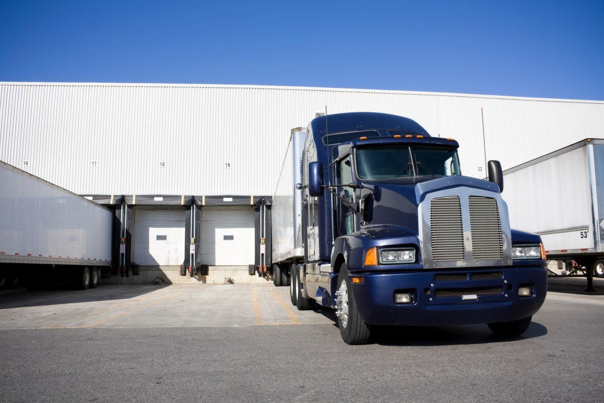 Blue Tranport Truck Docking in warehouse
