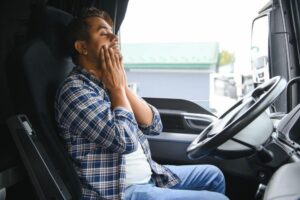 truck driver rubbing his face