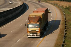 Bronze truck driving along road