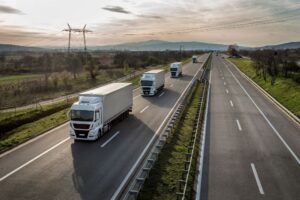 several trucks driving on a highway