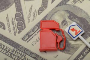 toy fuel tank on dollar bills