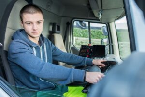 your truck driver looking in the truck side mirror