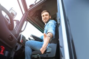 young truck driver extending his hand