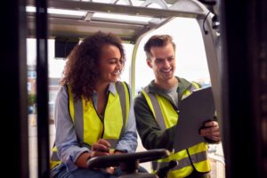 two people wearing safety vests checking regulations