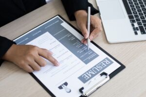person writing a resume