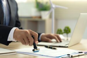 man stamping bank form