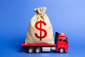 Red truck carrying a big bag of money