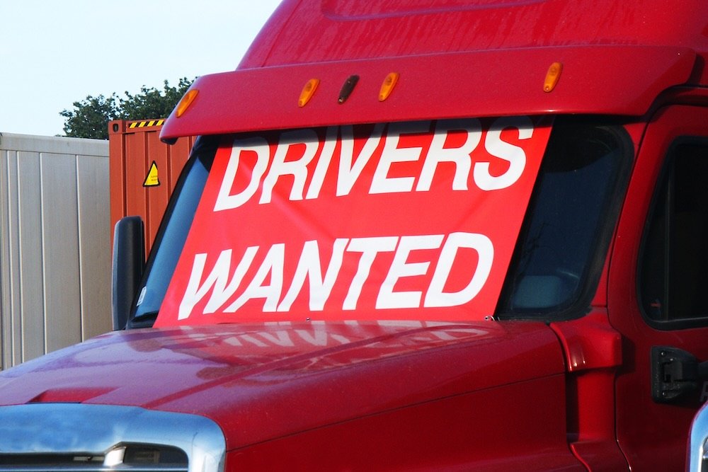 Drivers Wanted sign on red truck.