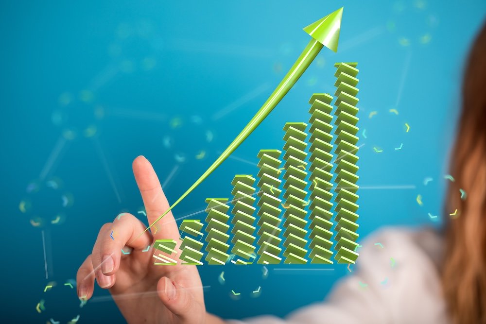 Stock photo of a hand interacting with a 3D upward trending graph, symbolizing growth and success.