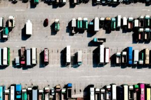 aerial view of commercial trucks parked in a depot