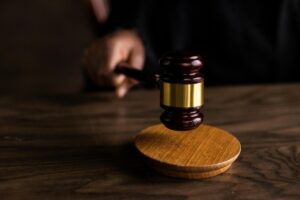 judge banging a gavel on a wooden platform
