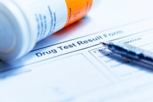 plastic container resting on a drug test form
