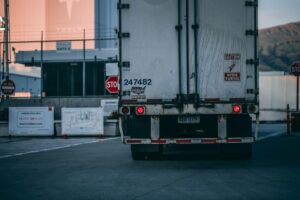 rear view of a white commercial truck awaiting entrance to a facility