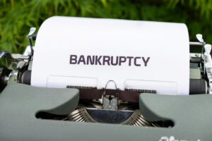 typewriter with "bankruptcy" typed on a page