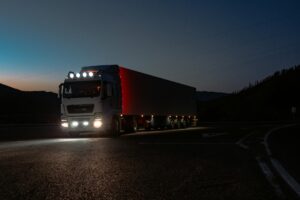 Truck driving along a road at night