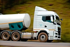 White truck driving along a road
