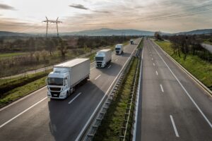 Convoy of trucks in line on a country highway