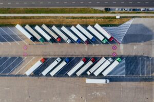 Aerial view of lines of trucks parked in a lot