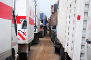 Image looking down the middle of two rows of trucks