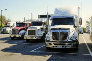 Front view of several trucks parked in a parking lot