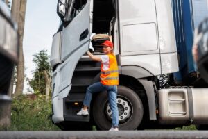 Portrait young adult happy smiling woman climbing cabin heavy truck driver cargo vehicle.