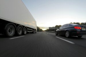 truck and car driving on road