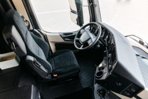 The interior of the cabin of a new modern truck. steering wheel, pedals, seat included, multimedia