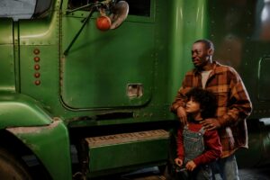 truck driver showing his truck to his son