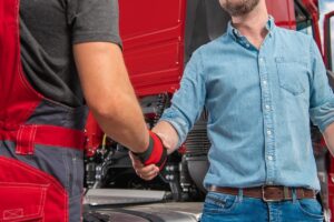 Truck drivers shaking hands