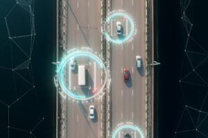 aerial view of vehicles driving on a highway with technology tracking them