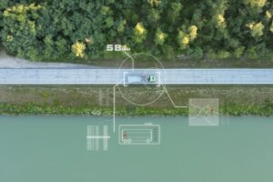Aerial footage of a truck and its speed and route being tracked as it drives along a road