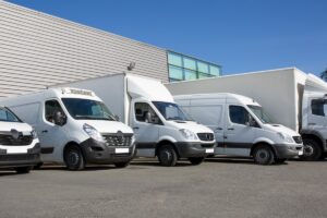 Different types of light commercial vehicles parked in a row