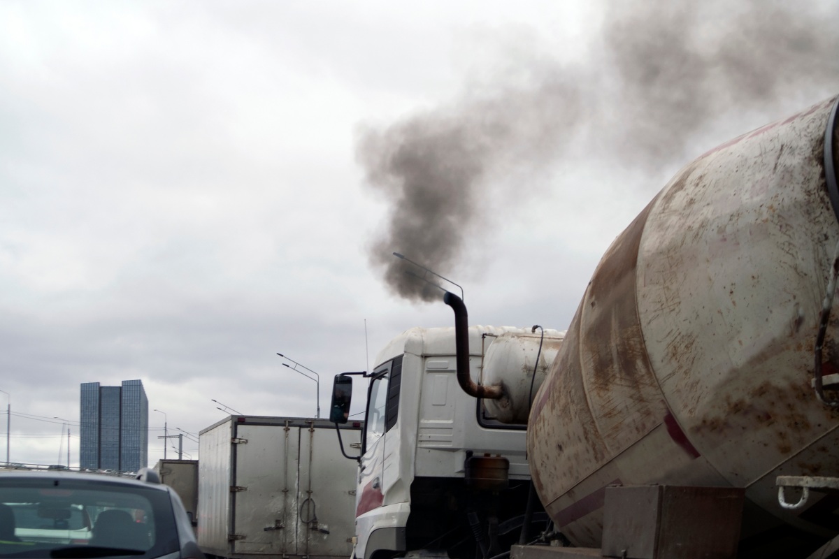 smoky truck in a traffic jam