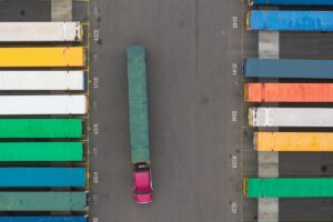 Aerial view of Colorful containers and Semi truck at Container yard.