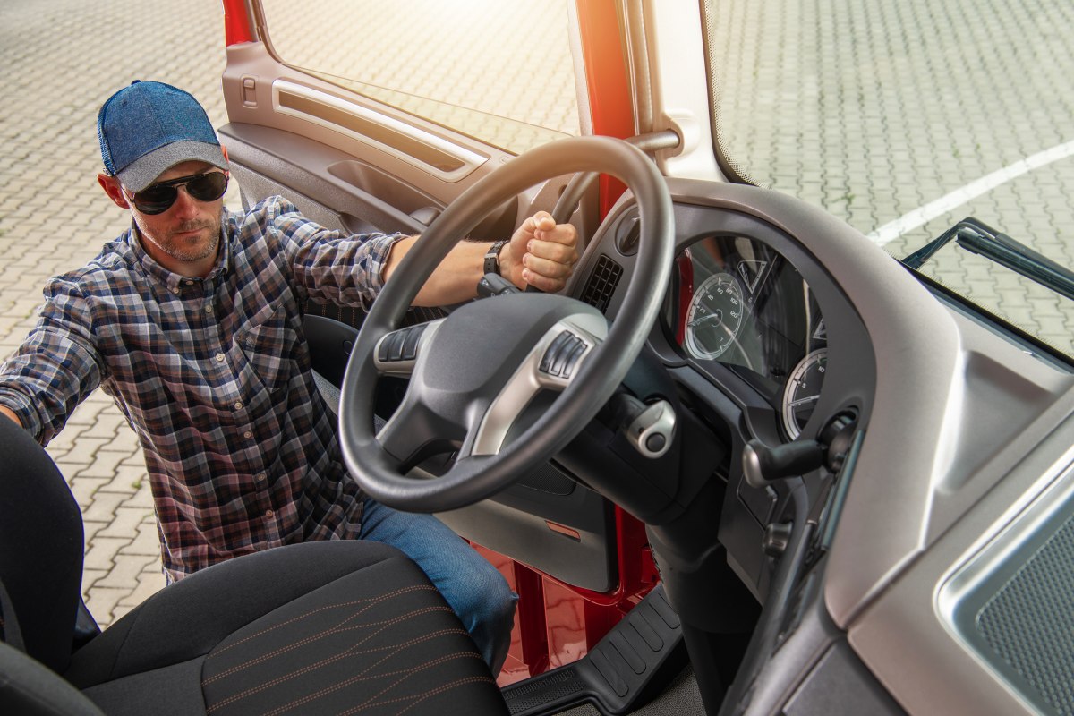 Caucasian Semi Truck Driver Hitting the Road