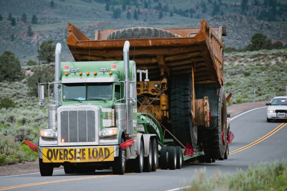 Oversized load truck with a police escort
